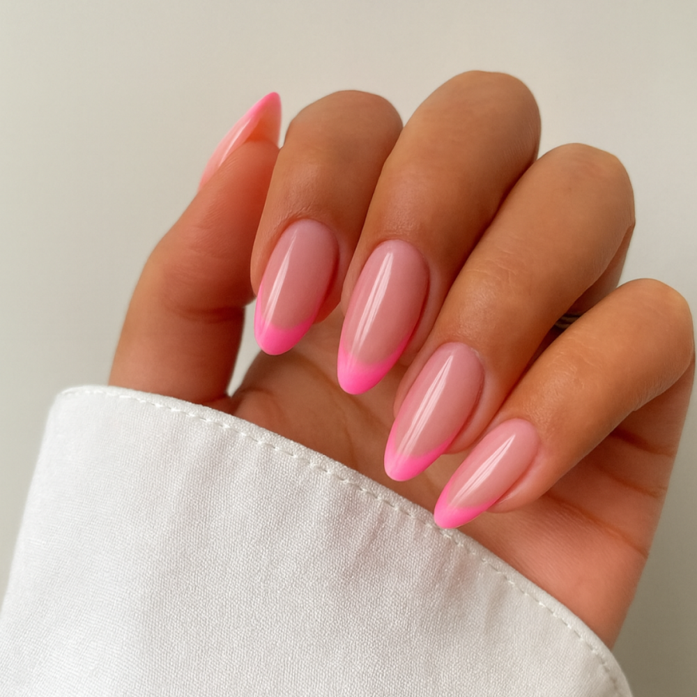 Hand with pink and white gradient nails on a neutral background